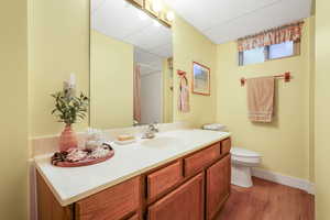Bathroom with vanity, dark wood-style floors, and shower