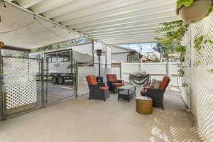 View of patio / terrace featuring a gate, outdoor lounge area, and area for grilling
