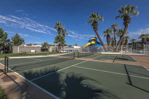 View of tennis court with community basketball court
