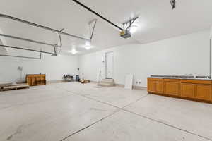 Garage with a sink and a garage door opener