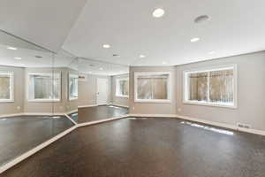Unfurnished room with recessed lighting and baseboards