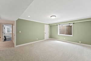 Unfurnished room with carpet, crown molding, recessed lighting, and a textured ceiling
