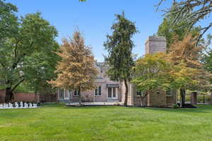 View of front of home with a patio and brick siding