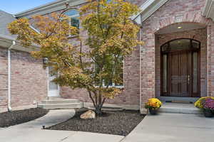 Entrance to property featuring brick siding