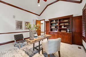 Office with light colored carpet, ornamental molding, high vaulted ceiling, a ceiling fan, and recessed lighting