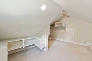 Bonus room featuring light colored carpet and lofted ceiling