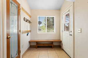 Mudroom with light tile patterned flooring and baseboards