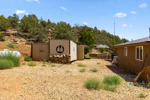 View of yard featuring a storage unit