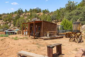 Back of property featuring a shed and a wooden deck