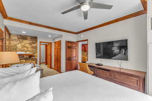Bedroom with ornamental molding, light tile patterned floors, a ceiling fan, ensuite bathroom, and recessed lighting