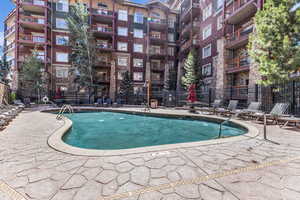 Community pool with a patio area