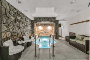 View of pool with a swimming pool and an in-ground hot tub