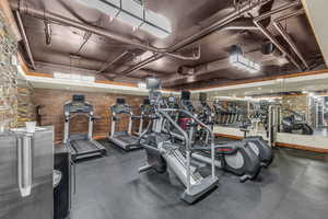 Exercise room featuring wooden walls