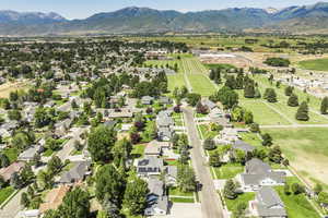 Aerial view of sparsely populated area featuring nearby suburban area and mountains