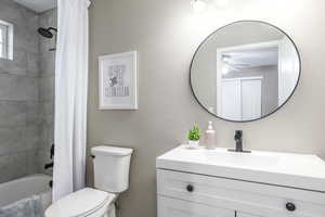 Bathroom featuring shower / bathtub combination with curtain and vanity