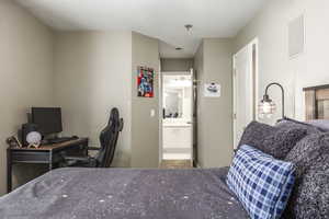 Bedroom with ensuite bath and a desk