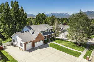 Aerial view of property and surrounding area with a mountainous background