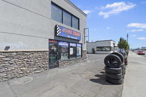 View of commercial property featuring uncovered parking