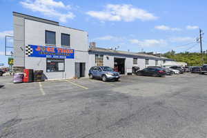 View of property with uncovered parking