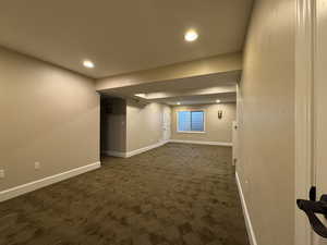 Spare room with dark carpet and recessed lighting