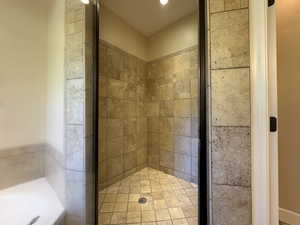 Full bath with a stall shower and a garden tub