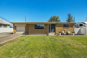 Single story home with brick siding, a garage, and concrete driveway