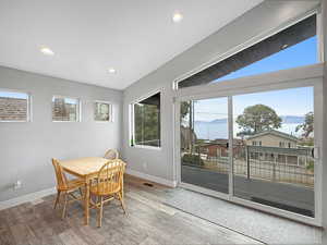 Dining room with a mountain view, recessed lighting, healthy amount of natural light, and wood finished floors
