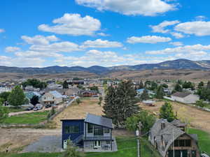 Aerial perspective of suburban area featuring a mountainous background