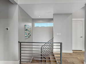 Staircase featuring baseboards and wood finished floors