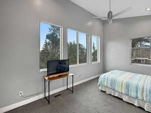 Carpeted bedroom featuring baseboards and ceiling fan