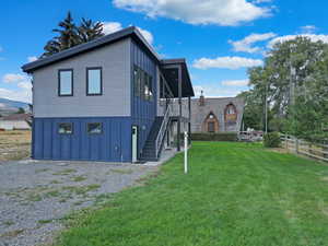 View of front of home featuring board and batten siding, stairs, and a mountain view