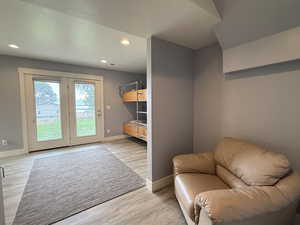 Sitting room with recessed lighting and light wood-type flooring