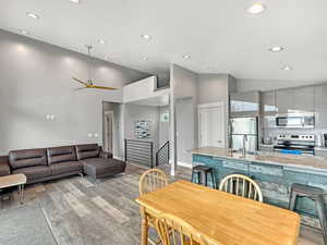 Dining area featuring recessed lighting, high vaulted ceiling, light wood-style floors, and ceiling fan