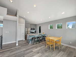 Dining area with plenty of natural light, recessed lighting, light wood-style flooring, and lofted ceiling