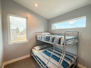 Carpeted bedroom featuring recessed lighting and lofted ceiling