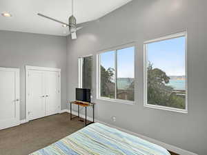 Bedroom with dark carpet, a closet, recessed lighting, and a ceiling fan