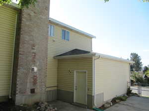 Back of property with a gate and a chimney