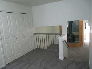 Stairs with a wood stove and carpet