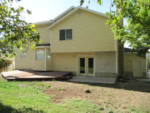 Back of property featuring a patio area, french doors, and a lawn