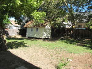 Fenced backyard with a storage shed