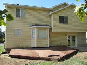 Rear view of house featuring french doors and a deck