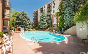 Community pool featuring a patio