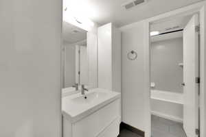 Bathroom with vanity and tile patterned flooring