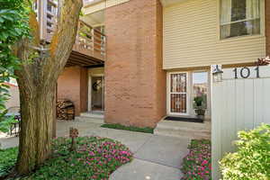 View of exterior entry featuring brick siding