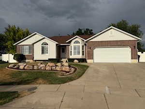Ranch-style home with concrete driveway, a garage, and brick siding