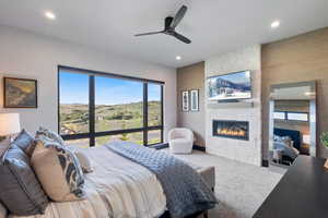 Bedroom featuring carpet floors, a fireplace, ceiling fan, and recessed lighting