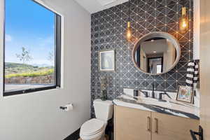Bathroom featuring vanity, tile walls, and decorative backsplash