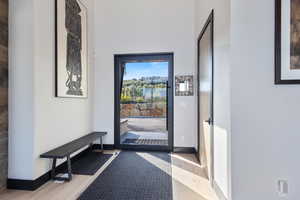 Doorway to outside featuring wood finished floors and baseboards