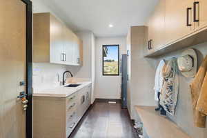 Kitchen featuring light brown cabinets, dark tile patterned flooring, and modern cabinets