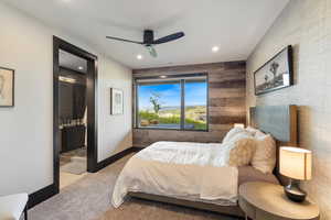 Carpeted bedroom featuring ceiling fan, recessed lighting, and ensuite bathroom